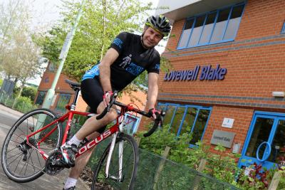 Charity cyclist Paul Milton pictured outside Lovewell Blakes Bury St Edmunds office