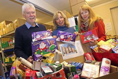 Kari Ashling right from Victory Housing Trust presents the Christmas goodies to Tim Morton and Miranda Hall sm