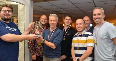 Matthew Waters of Lovewell Blake left presents the trophy to the winning team from Barclays