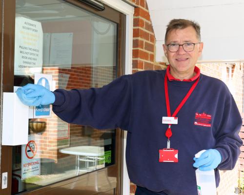 Broadland Housing Association chief executive Michael Newey sanitising at York Place in Dereham sm