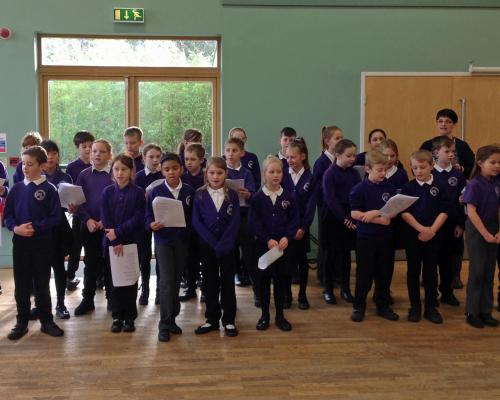 Children from Swaffham Primary Academy singing to members of the towns Wellbeing Group