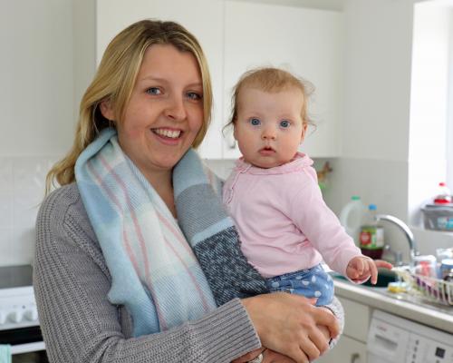 Emma Payne and baby Lily in the kitchen of their new home