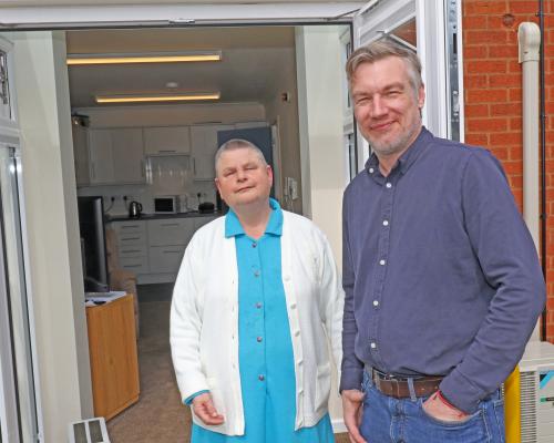 Hammond Court resident Kate Pentney outisde the patio doors of her flat with Vision Norfolk chief executive Andrew Morter