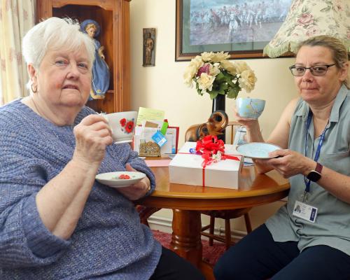 Helen King of Vision Norfolk right delivers a Jubilee tea to Flora Hamill sm