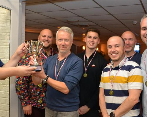 Matthew Waters of Lovewell Blake left presents the trophy to the winning team from Barclays