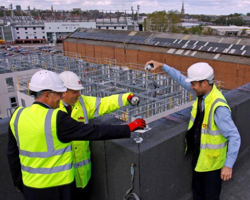 Michael Newey left and Andrew Savage centre from Broadland Housing top out Canary Quay with James Carter of RG Carter