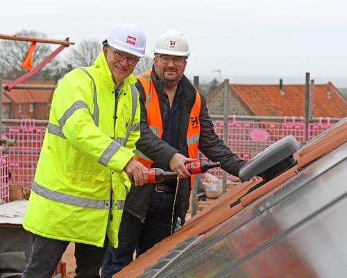 Michael Newey left and Jonathan Smith top out the new affordable homes in Salthouse sm