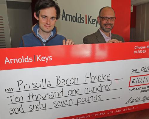 Nick Williams of Arnolds Keys left presents a cheque to Hugo Stevenson of the Priscilla Bacon Hospice charity sm