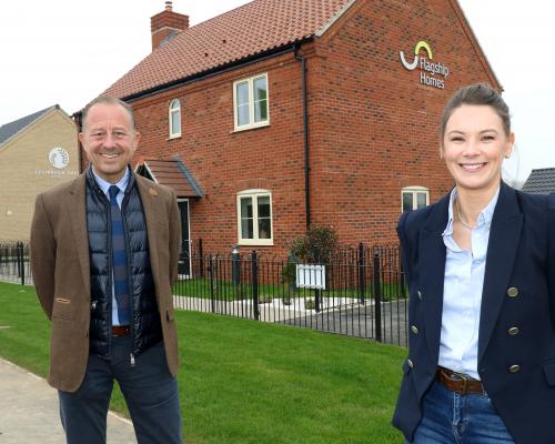 Paul Pitcher of Wellington and Charlotte Mowforth of Flagship Homes celebrate the handing over of 11 new homes at Ellingham Green