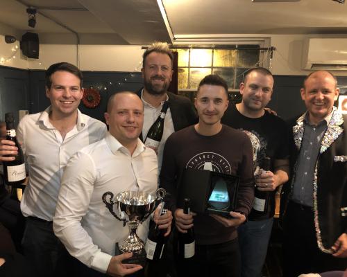 The victorious team from Barclays receives the trophy from Mark Mayhew of Arnolds Keys right