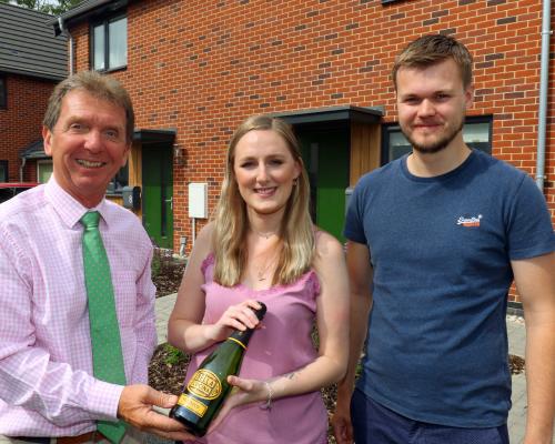 Tony Abel left of Abel Homes with Sian Smith and Alex Williams outside their new home in Swaffham sm