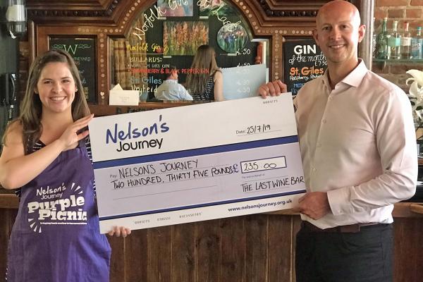 Sarah Dodge of Nelsons Journey receives the Purple Pudding cheque from Mark Loveday of the Last Wine Bar sm