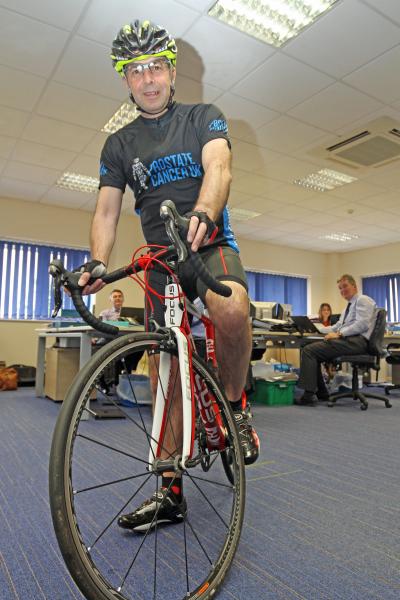 Accountant Paul Milton prepares for his charity bike ride in the Lovewell Blake offices in Bury St Edmunds