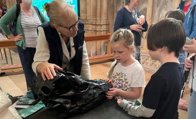 Blind youngster Laurel Allen handles the replica Diplodocus skull