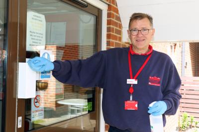 Broadland Housing Association chief executive Michael Newey sanitising at York Place in Dereham sm