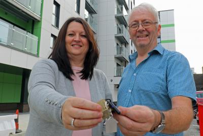 Canary Quay tenant Andrew Parfitt receives his keys from Paula Strachan of Broadland Housing Association sm