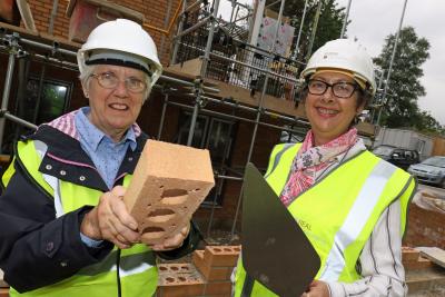Carol Sangster left and Cllr Gail Harris lay the Golden Brick at Leander Court in Norwich 1