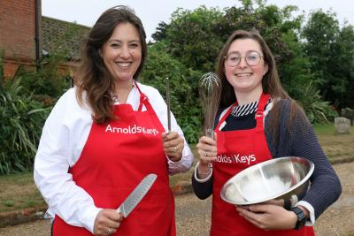 Charlotte Hayward left and Lizzie Allen prepare to do battle on the Aylsham Show cookery stage sm