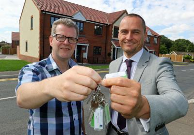 Chris Dove of Dove Jeffery right hands the keys to 21 new affordable homes in Roughton to Victory Hosuing Trusts John Archibald