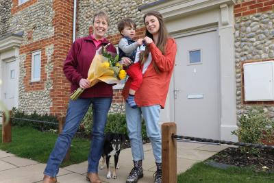 Christine Candlish of Victory Housing Trust left hands the keys over to Caitlin Finan son Alfie and dog Jessie