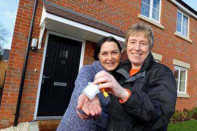 Christine Candlish right of Victory hands over the keys of her new home to Erika Krauzaite sm