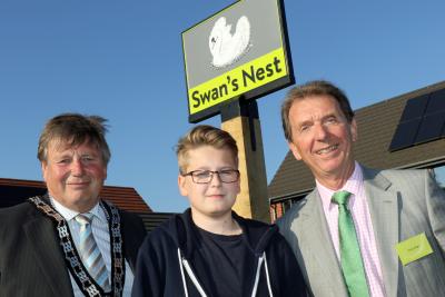 Cllr Colin Houghton Elliot Clark and Tony Abel in front of the new village sign at Swans Nest in Swaffham