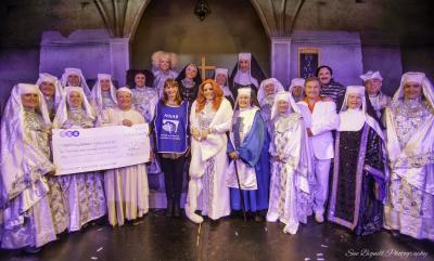 Donna Minto of the NNAB receives a cheque from the cast of Sister Act
