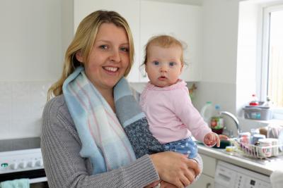Emma Payne and baby Lily in the kitchen of their new home