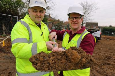 Gary Waterton of Draper Nichols left and John Archibald of Victory Housing Trust cut the first sod at Barons Close