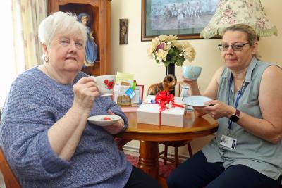 Helen King of Vision Norfolk right delivers a Jubilee tea to Flora Hamill sm