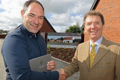 Housebuyer Phil Royle left is congratulated by Tony Abel on being the first to buy a new home at The Limes in Little Melton