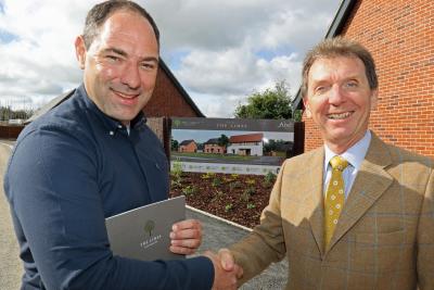 Housebuyer Phil Royle left is congratulated by Tony Abel on being the first to buy a new home at The Limes in Little Melton