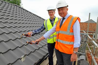 John Archibald left and Paul Pitcher top out the new affordable homes at Briston 1
