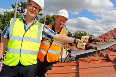 John Archibald left of Victory and Steve Tomkins of Draper Nichols top out the new homes in Fakenham