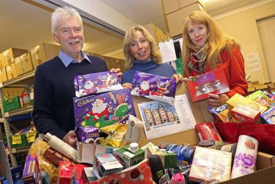 Kari Ashling right from Victory Housing Trust presents the Christmas goodies to Tim Morton and Miranda Hall sm