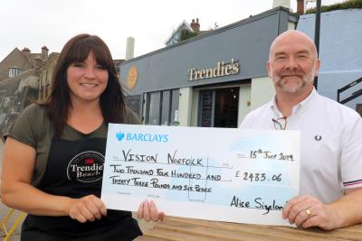 Marathon runner Alice Sizeland presents the cheque to Clive Evans of the NNAB sm