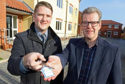 Mark Abbott left of Draper Nichols hands the keys to the new homes in Fakenham to Victory Housing Trusts John Archibald sm