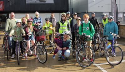 Matthew Reil red hair green top with fellow cyclists on the sponsored cycle ride