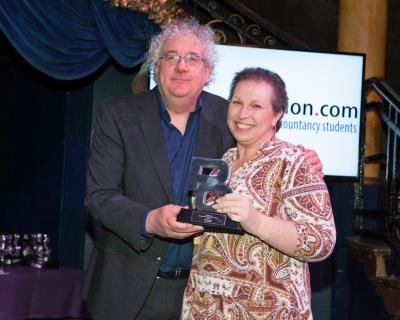 Melanie Wright from Lovewell Blake receives her award from Adam Riches of PQ Magazine