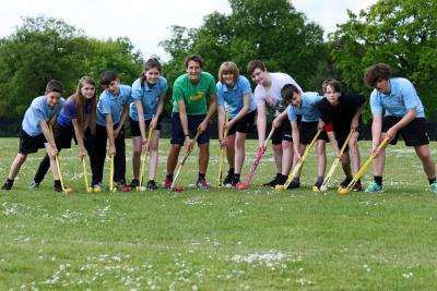 Members of the NWHS Hockey Club with former England player and NWHS teacher Tim Whiteman centre green shirt
