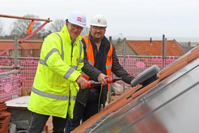 Michael Newey left and Jonathan Smith top out the new affordable homes in Salthouse sm