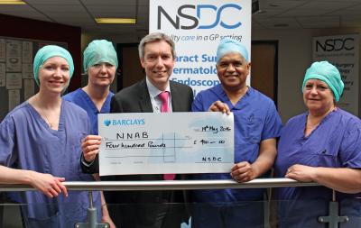 Mike Talbot from the NNAB receives a cheque for 400 from the cataract surgery team at St Stephens Gate medical practice in Norwich