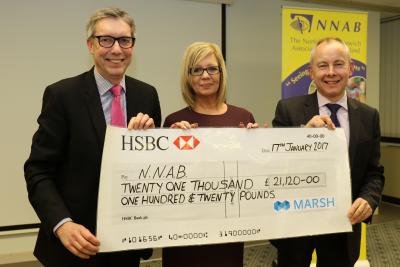 Mike Talbot left and Julie Lythgoe of the NNAB receive the cheque from Alan Cross of Marsh