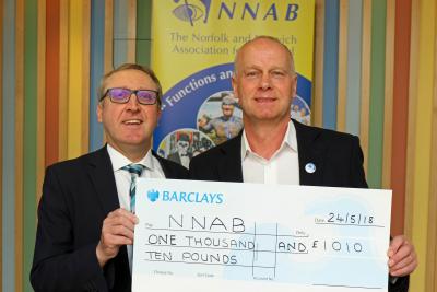 Miles Fagan left of Barclays Bank presents a cheque for the money raised on the charity quiz night to Jeremy Goss of the NNAB sm