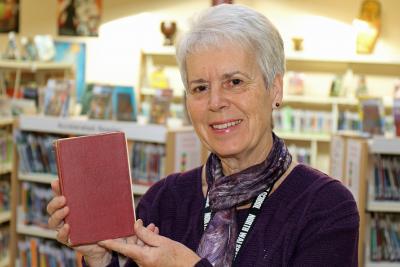 NWHS librarian Liz Sawyer with the overdue book from 1953 which has been returned