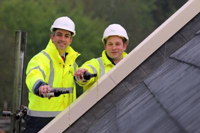 Paul LeGrice left and Alan Hawkins from Abel Homes top out the first of the new homes at Gressenhall sm