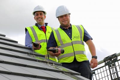 Paul LeGrice left and Danny Pinner top out the first new home at Abel Homes Bluebell Rise site in Bawdeswell sm