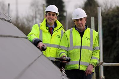 Paul Legrice left and Alan Read of Abel Homes perform the traditional topping out ceremony at Little Melton
