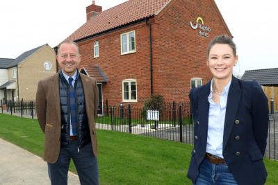 Paul Pitcher of Wellington and Charlotte Mowforth of Flagship Homes celebrate the handing over of 11 new homes at Ellingham Green