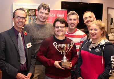 Paul Sullivan of Arnolds Keys presents the Sports Challenge trophy to Larking Gowen